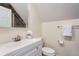 Half-bath featuring a modern vanity, sink, mirror and modern finishes at 2163 S Grant St, Denver, CO 80210