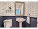 Charming powder room with unique wallpaper, a pedestal sink, and elegant fixtures at 2163 S Grant St, Denver, CO 80210