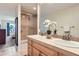 Bathroom boasts double sinks, decorative mirror, a tiled shower and a view into an adjacent bedroom at 2163 S Grant St, Denver, CO 80210