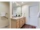 Bathroom featuring double sinks, a large mirror, a tiled countertop, and a decorative rug at 2163 S Grant St, Denver, CO 80210