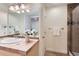 Well-lit bathroom with a tiled countertop, decorative accents, and a walk-in shower at 2163 S Grant St, Denver, CO 80210
