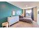 Bright bedroom with blue accent wall, complemented by a bed with matching linens and ample natural light at 2163 S Grant St, Denver, CO 80210