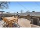 Spacious wooden deck with outdoor seating and a grill, ideal for outdoor dining and relaxation at 2163 S Grant St, Denver, CO 80210