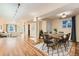 Open-concept dining area with hardwood floors, stylish lighting, and ample space for entertaining guests at 2163 S Grant St, Denver, CO 80210