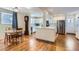 Modern white kitchen with stainless steel appliances, a breakfast nook, and hardwood floors at 2163 S Grant St, Denver, CO 80210