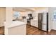 Well-lit kitchen featuring stainless steel appliances, white cabinets, and hardwood floors at 2163 S Grant St, Denver, CO 80210