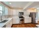 Stylish kitchen with stainless steel appliances, marble counters, and hardwood floors at 2163 S Grant St, Denver, CO 80210