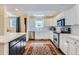 Bright kitchen with white cabinetry, stainless steel appliances, and hardwood floors at 2163 S Grant St, Denver, CO 80210
