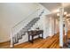 Bright staircase with carpeted steps, wooden floors, and white banister at 2163 S Grant St, Denver, CO 80210