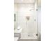 Modern bathroom shower with a glass door, built in bench, and stylish white tiling at 2659 S Cherokee St, Denver, CO 80223