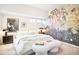 Bright bedroom with a unique jungle themed wall, plush bedding, and modern furnishings at 2659 S Cherokee St, Denver, CO 80223