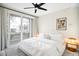 Modern bedroom with a sliding glass door, balcony access, and a stylish ceiling fan at 2659 S Cherokee St, Denver, CO 80223