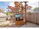 Wooden playhouse sits in a fenced backyard with mature tree canopy at 1172 S Zeno Way # F, Aurora, CO 80017