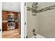 Modern bathroom with tiled shower and stainless steel kitchen view at 1172 S Zeno Way # F, Aurora, CO 80017