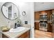 Bright bathroom features a granite countertop and modern black fixtures at 1172 S Zeno Way # F, Aurora, CO 80017
