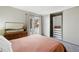 Bright bedroom features a mirrored closet and sliding glass door to backyard at 1172 S Zeno Way # F, Aurora, CO 80017