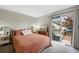 Cozy bedroom offers access to the backyard and features a dresser and bedside table at 1172 S Zeno Way # F, Aurora, CO 80017