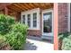 Inviting front entrance with brick facade, white trim, and a welcoming doormat at 1172 S Zeno Way # F, Aurora, CO 80017