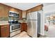 Charming kitchen features stainless steel appliances, wood cabinets and eat in breakfast nook at 1172 S Zeno Way # F, Aurora, CO 80017