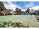 Well-maintained community tennis court surrounded by mature trees and landscaping at 1172 S Zeno Way # F, Aurora, CO 80017