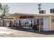 Exterior view of Edward's Meats with outdoor picnic tables and mountain mural on the windows at 4517 Tabor St, Wheat Ridge, CO 80033