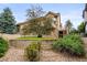 Lush backyard featuring a stone wall, mature trees and access to the upper deck at 6542 S Tempe St, Aurora, CO 80016