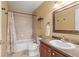 Well-lit bathroom with a shower-tub combo, vanity and tile flooring at 6542 S Tempe St, Aurora, CO 80016