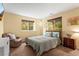 Cozy bedroom with two windows, natural light and neutral decor with a ceiling fan at 6542 S Tempe St, Aurora, CO 80016