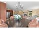 Open floor plan with a dining area showcasing a hardwood table, six leather chairs, and stainless steel appliances at 6542 S Tempe St, Aurora, CO 80016