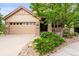 Lovely home featuring a stone facade, a well-manicured lawn, and a two-car garage at 6542 S Tempe St, Aurora, CO 80016