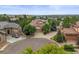 Well-maintained home featuring a circular driveway and beautiful landscaping at 6542 S Tempe St, Aurora, CO 80016