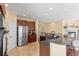 Open kitchen with stainless steel appliances, tile flooring, and spacious cabinetry at 6542 S Tempe St, Aurora, CO 80016