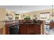 Bright kitchen with a breakfast bar and seamless view into the living area at 6542 S Tempe St, Aurora, CO 80016