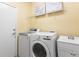 Functional laundry room with modern washer, dryer, and utility sink at 6542 S Tempe St, Aurora, CO 80016