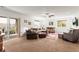Spacious living room with carpet, natural light and a sliding glass door to the exterior at 6542 S Tempe St, Aurora, CO 80016