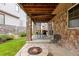 Covered patio with stone columns, fire pit, outdoor furniture and grill for entertaining at 6542 S Tempe St, Aurora, CO 80016