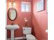 Stylish powder room with pedestal sink and charming decor at 6542 S Tempe St, Aurora, CO 80016