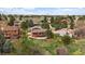 Aerial view of a home surrounded by mature trees and greenery, set within a neighborhood at 8072 Windwood Way, Parker, CO 80134