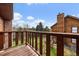 Balcony has wood plank flooring and a wood railing overlooking backyard at 8072 Windwood Way, Parker, CO 80134