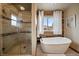 Stylish bathroom featuring a soaking tub and glass-enclosed shower with natural light at 8072 Windwood Way, Parker, CO 80134