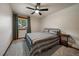Bedroom with carpet, ceiling fan, large window, and neutral colors at 8072 Windwood Way, Parker, CO 80134