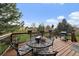 Outdoor deck with a table and chairs, a barbecue, and views of the neighborhood at 8072 Windwood Way, Parker, CO 80134