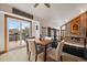 Dining area with modern table setting, access to deck, and a view of the living room fireplace at 8072 Windwood Way, Parker, CO 80134
