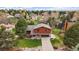 A beautiful home with green lawn, driveway and landscaping throughout the property with mature trees at 8072 Windwood Way, Parker, CO 80134