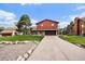 Two-story home with a stone and wood facade, and a driveway at 8072 Windwood Way, Parker, CO 80134