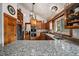 Open kitchen with granite countertops, stainless steel appliances, and wooden cabinetry at 8072 Windwood Way, Parker, CO 80134