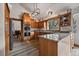 Modern kitchen with stainless steel appliances, granite countertops, wooden cabinets, and a view to the dining area at 8072 Windwood Way, Parker, CO 80134