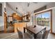Bright kitchen with granite island and stainless steel appliances, leading to dining area and outdoor deck at 8072 Windwood Way, Parker, CO 80134