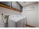 Bright laundry room has washer and dryer hookups, storage, and recessed lighting at 8072 Windwood Way, Parker, CO 80134