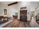 Open-concept living room with a high ceiling, wood floors, and a view of the dining area and kitchen at 8072 Windwood Way, Parker, CO 80134